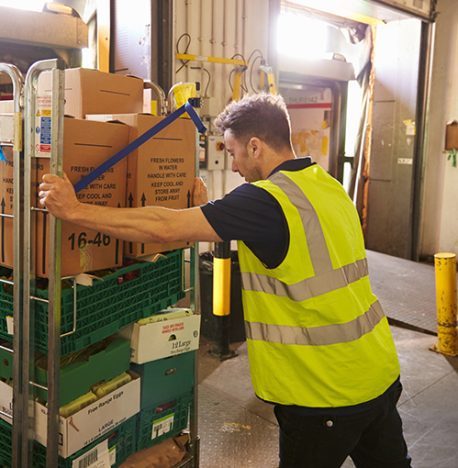 Man pushing cage pallet